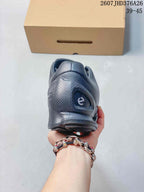 Rear view of the black sneaker showing the padded heel area, textured heel panel, and outsole.