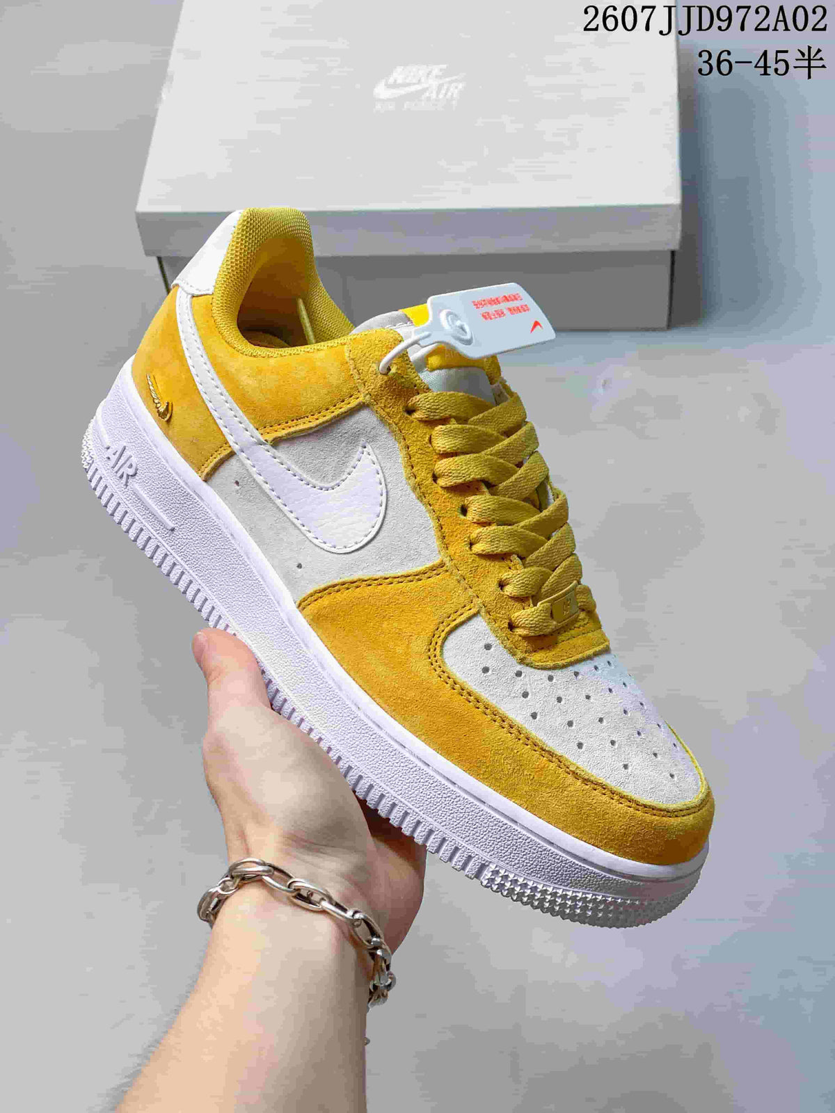 Close-up side view of a yellow and white low-top Nike Air Force 1 '07 sneaker