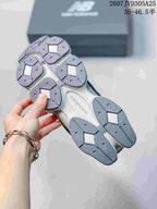 Underside view showing the segmented grey outsole and tread pattern of the sneakers.