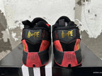 Rear view of red and black BAPE and adidas basketball shoes with gold-tone heel branding