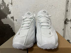 Front view of white Nike NOCTA Glide sneakers showing the laces and rounded toe.