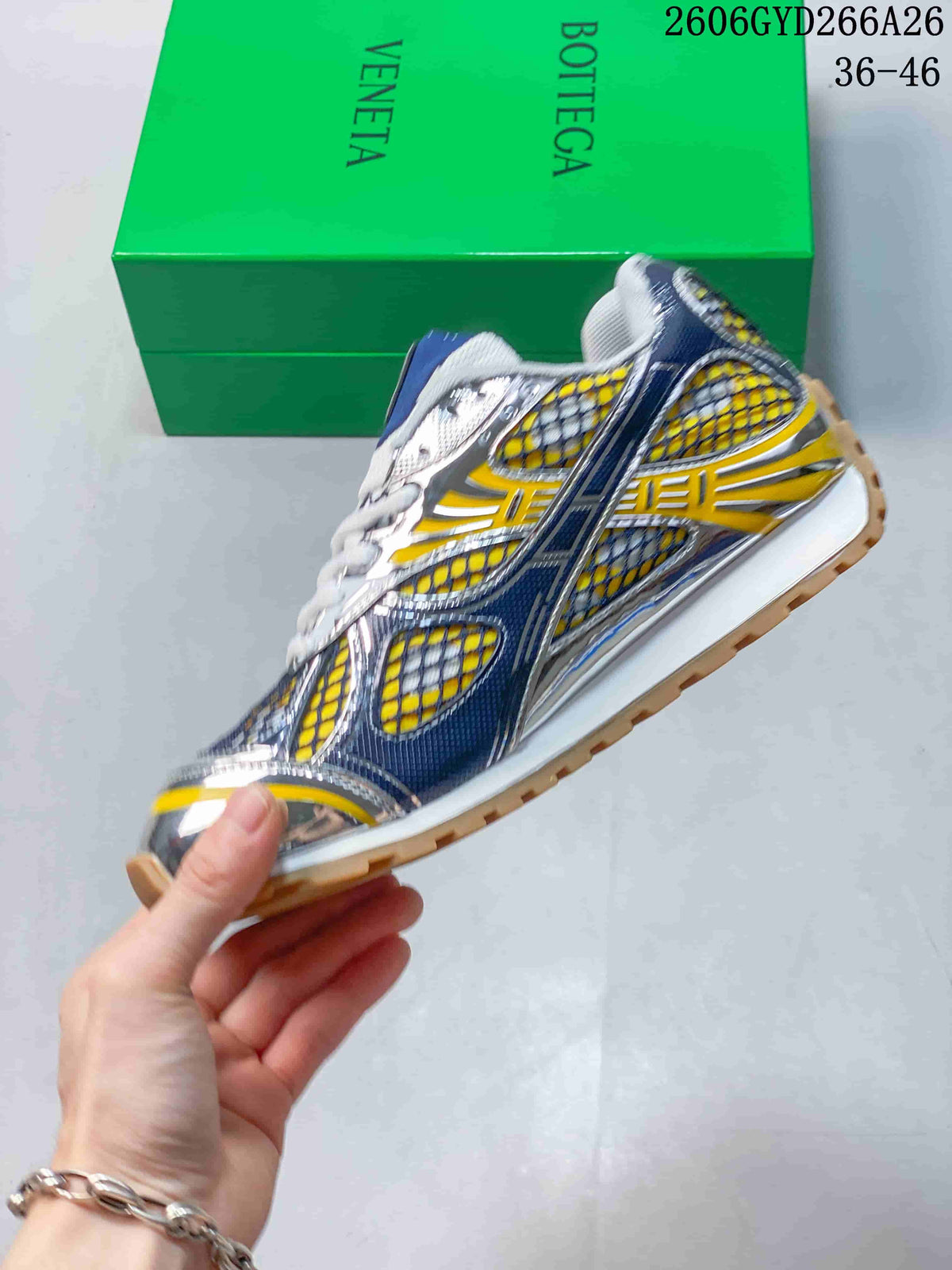 Side view of the yellow and blue Orbit sneaker with layered panels