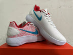 Pair of Nike low-top sneakers showing white and pink patterned panels, blue Swooshes, red trim, and ridged soles.
