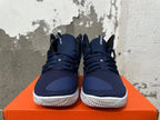 Front view of navy Nike basketball shoes with lace-up closure and white outsoles