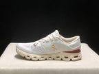 Lateral side view of a white On Cloud X4 sneaker with a low collar, lace-up front, burgundy heel accent, and segmented outsole.