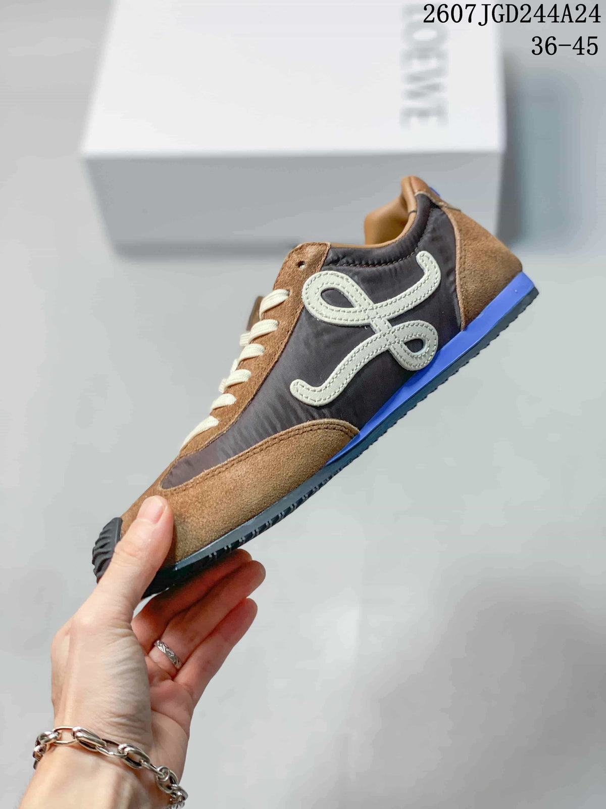 Side profile showing the brown and gray upper, cream side logo detail, blue heel accent, and low-top shape.