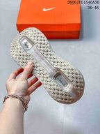 Close-up of the patterned outsole and tread on a mauve-gray sneaker