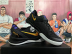 Pair of black Nike basketball shoes with yellow Swooshes, purple accents, and white outsoles