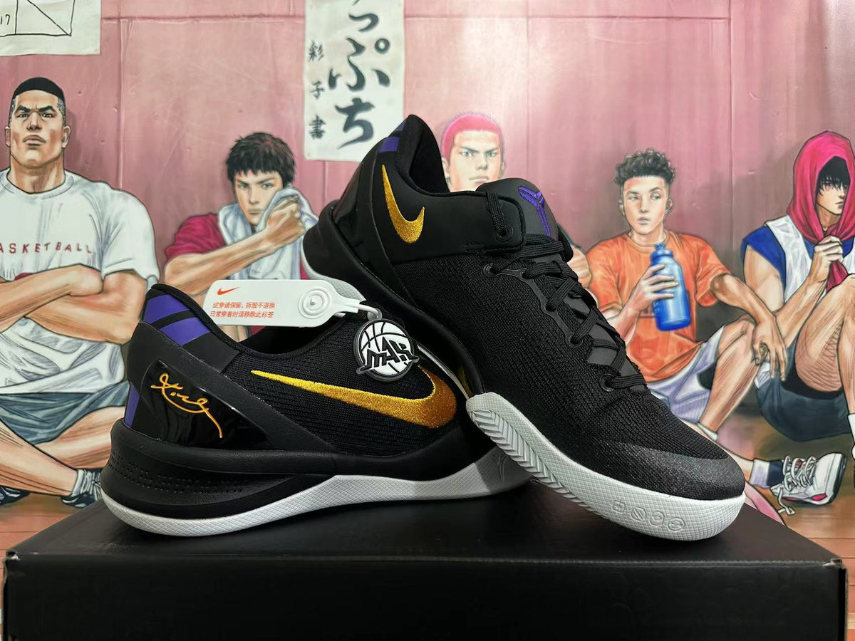 Pair of black Nike basketball shoes with yellow Swooshes, purple accents, and white outsoles