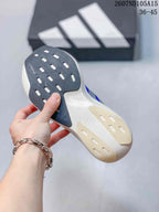 Close view of the sneaker outsole showing dark and light rubber sections with patterned traction grooves.