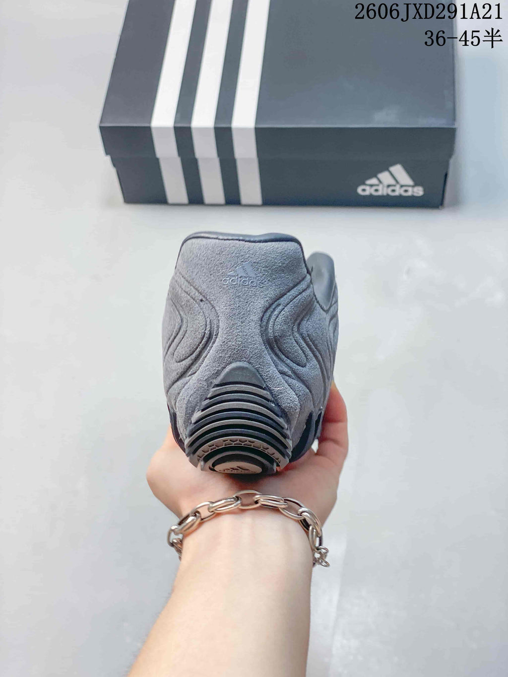 Rear view of the gray sneaker showing the padded collar, heel panel, and outsole detail.