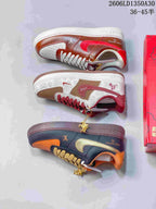 Side views of three sneaker colorways: brown and red, cream and burgundy, and navy and orange.