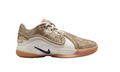 Side view of beige and white Nike LeBron 22 low-top basketball shoes with a dark purple Swoosh and gum-colored outsole