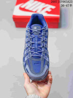 Top view showing the blue mesh upper, gray overlays, laces, and tongue branding