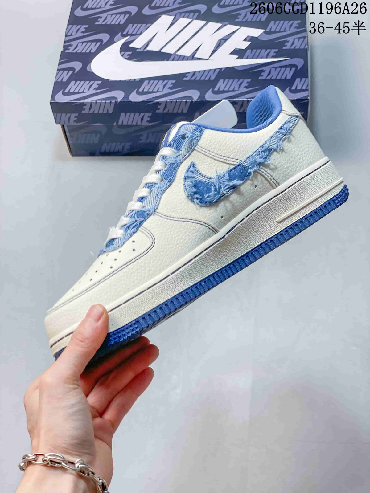 Side view of the white sneaker with a frayed blue denim Swoosh