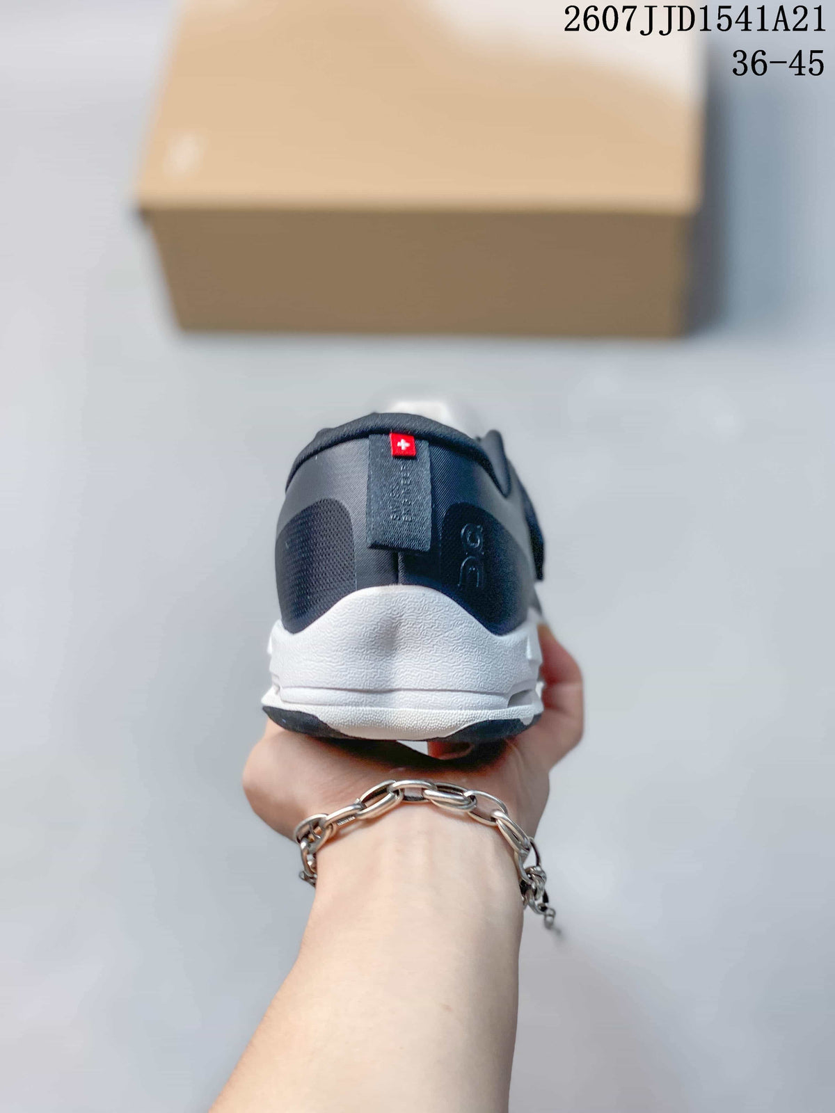 Rear view showing the padded heel collars, dark navy uppers and white midsoles.