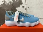 Side view of a blue Nike sneaker with a metallic-toned Swoosh and white ridged sole