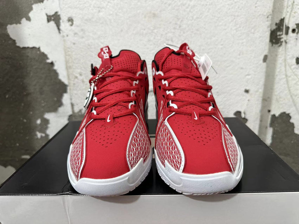 Front view of red basketball shoes with white patterned side panels and white soles.