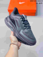 Angled side view showing the black and gray upper, Nike Swoosh, lace fastening, and cushioning midsole.