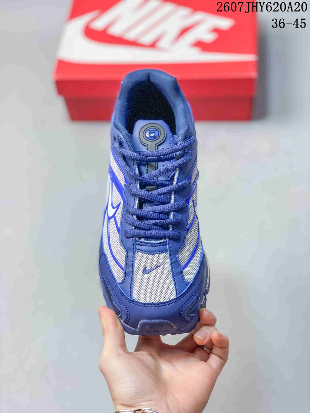 Top view of the blue and white lace-up sneaker showing the tongue, eyelets, laces and mesh-style toe panel.