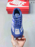 Top view of the blue and white lace-up sneaker showing the tongue, eyelets, laces and mesh-style toe panel.