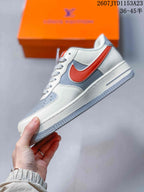 Side profile showing the white and grey upper, red side accent, low-top shape, and layered sole.