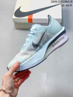 Side view of the pale blue and white shoe showing the dark Swoosh, textured upper, sculpted midsole, and visible ZoomX marking.