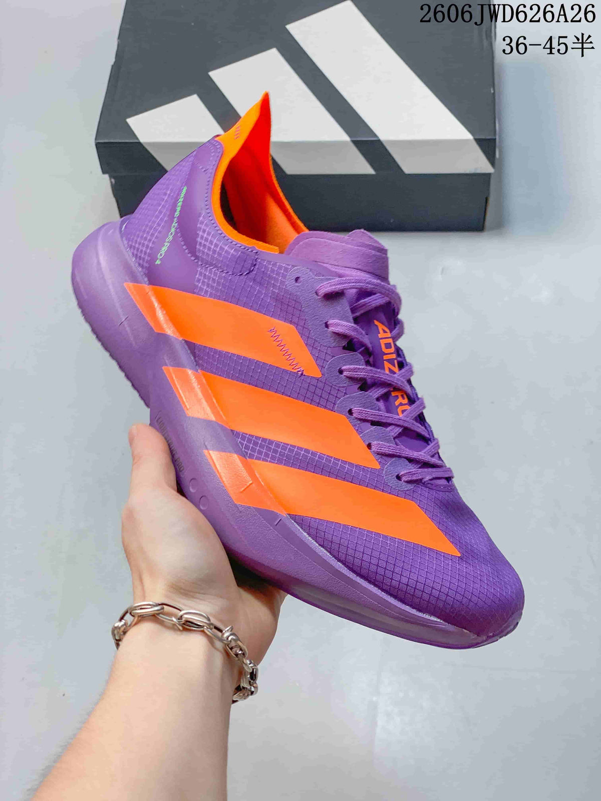 Purple running shoe with bright orange accents, shown in profile.