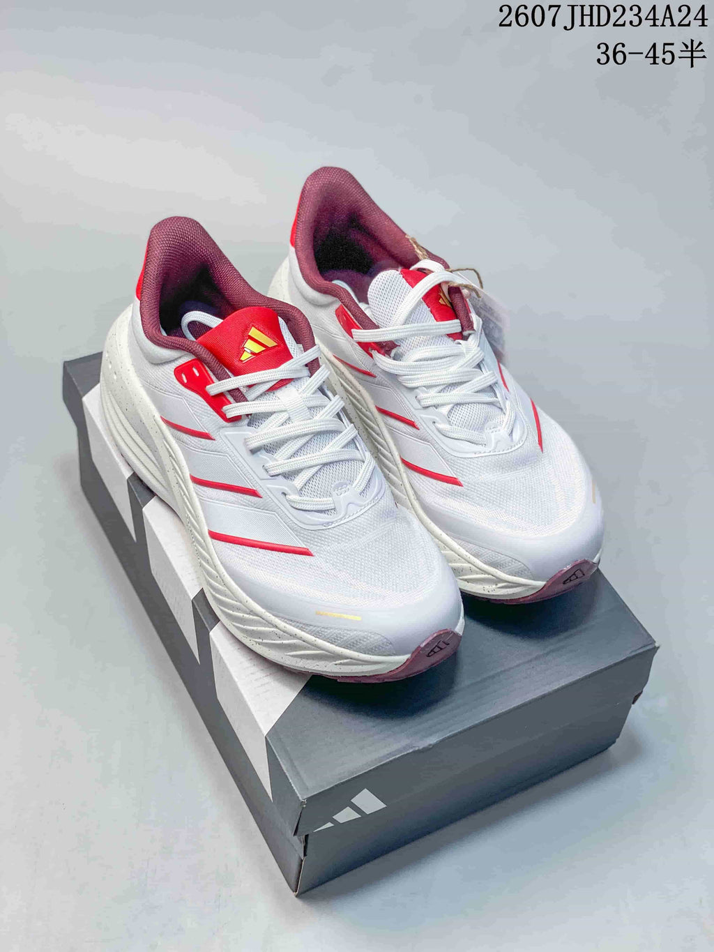 Pair of white and red adidas low-top sneakers displayed on an adidas shoebox; overlay text shows code 2607JHD234A24 and sizes 36–45.5.