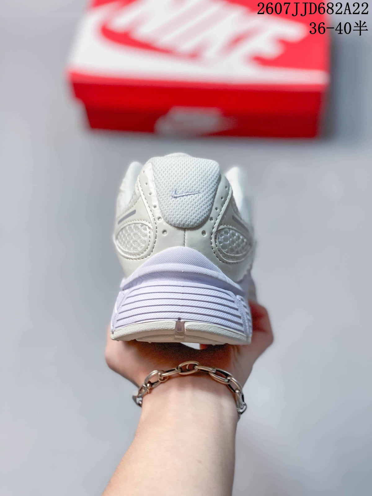 Rear view of the white Nike V5 RNR sneaker showing the padded heel collar, layered heel construction, and thick outsole.