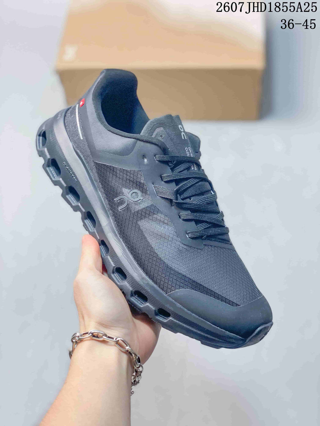 Three-quarter side view of the dark gray On Cloudvista 2 sneaker showing the side logo, textured upper, heel detail, and lugged outsole.