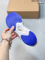 Underside view of a Nike running shoe showing blue patterned rubber outsole sections and a white midsole.