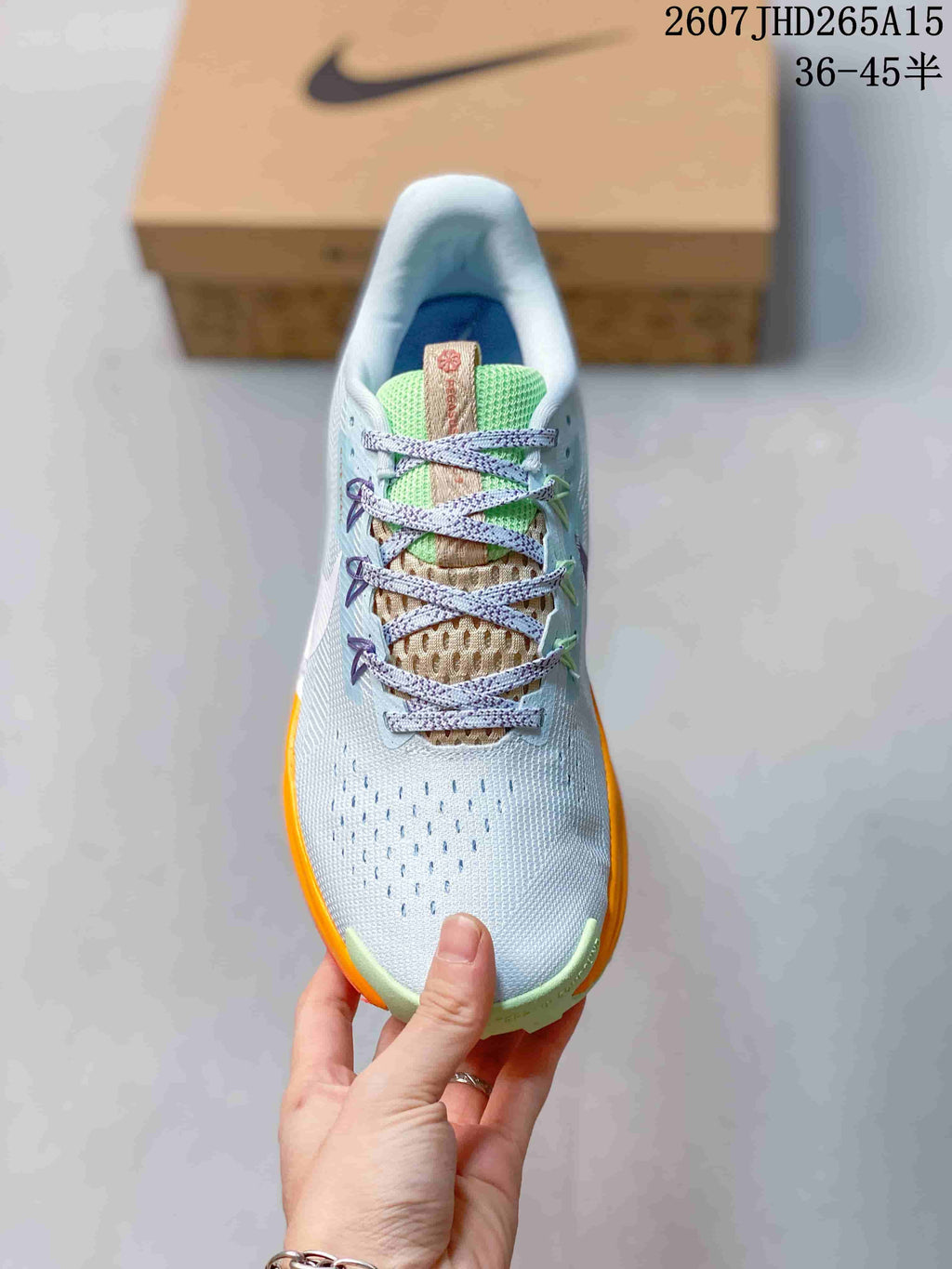 Top view of a Nike Pegasus Trail 5 sneaker showing the perforated toe area, patterned laces and green tongue.