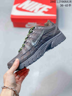 Side profile of a dark gray Nike P-6000 sneaker showing layered panels, side branding, and a textured midsole.