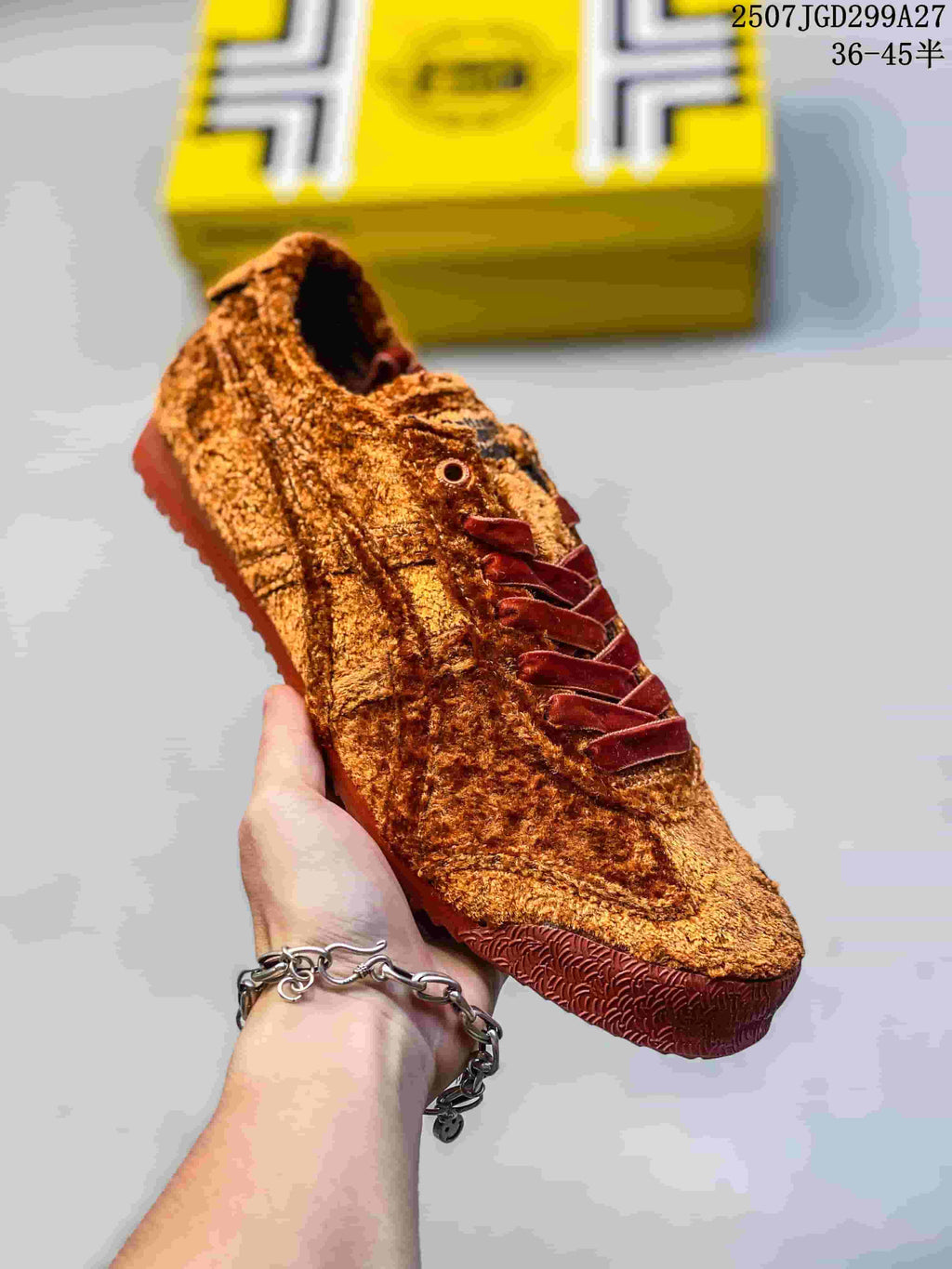 Angled side view of the brown sneaker showing the textured upper, lace system and patterned outsole.