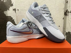 Pair of gray Nike Ja 1 basketball shoes, one displayed over the other