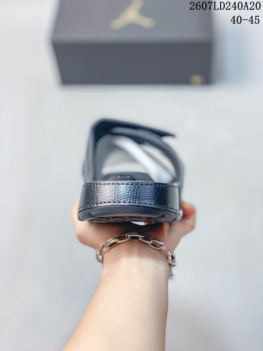 Rear view of a dark Jordan slide showing the heel and open sandal construction; style code 2607LD240A20 and size range 40–45 appear above.