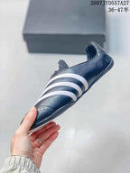 Side profile showing the black upper, white stripe details, and low rubber sole