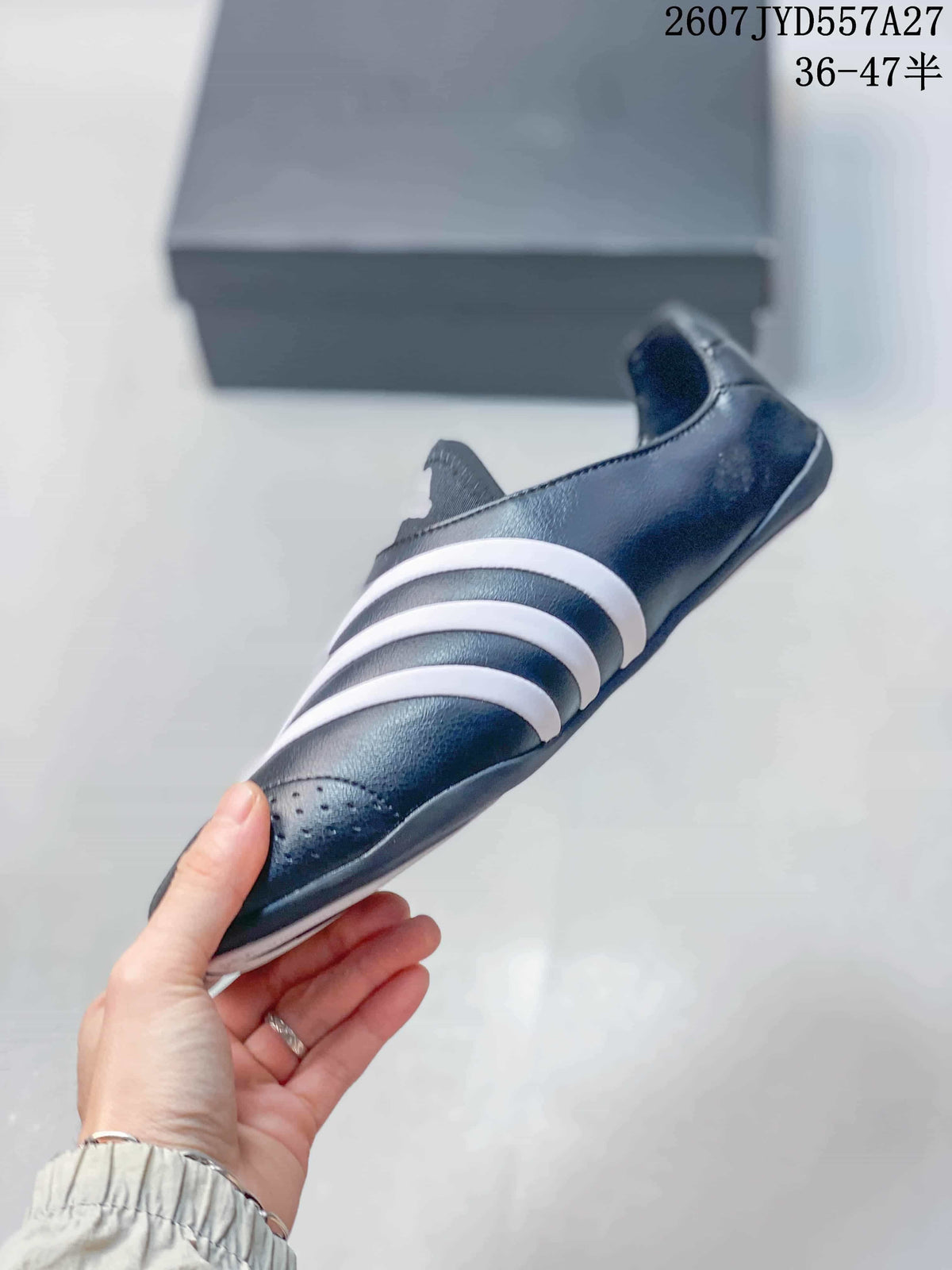 Side profile showing the black upper, white stripe details, and low rubber sole