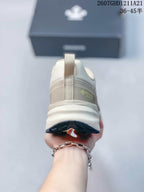 Rear view of the sneaker showing the heel pull tab, layered heel design, and outsole tread.