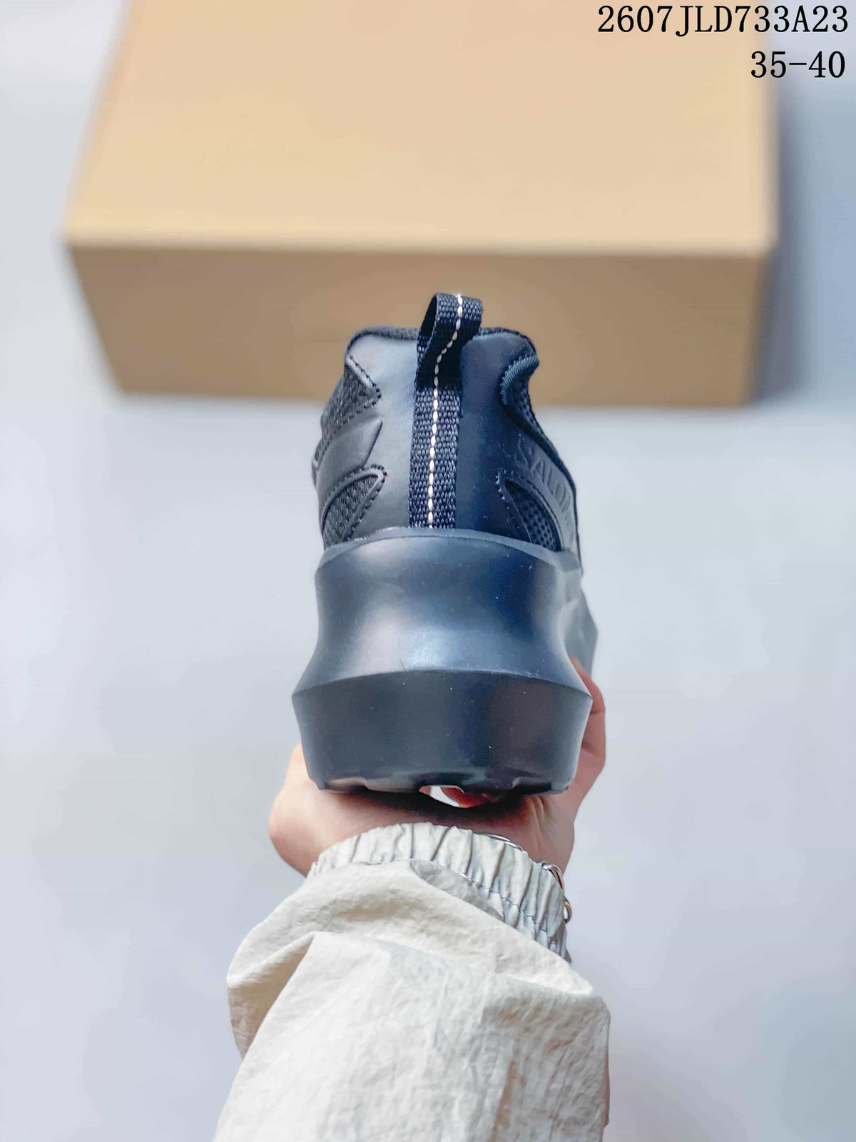 Rear view of the sneaker showing the padded heel, pull tab and chunky dark outsole.