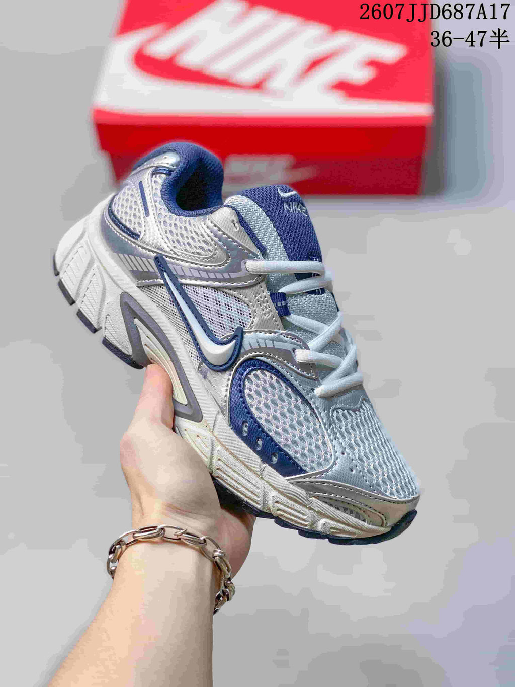 White and blue Nike V5 RNR sneaker shown from an angled front view.