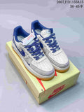 Pair of white, grey and blue Nike Air Force 1 sneakers displayed on a Nike shoe box, with the style code and size range visible at the top.