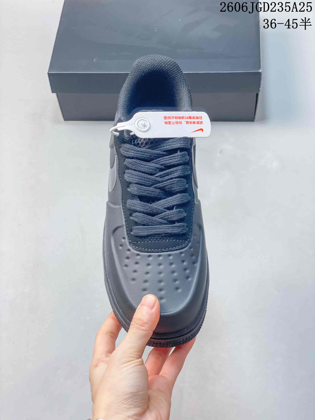 Top view showing the perforated toe box, lace-up fastening, padded tongue, and attached security tag.