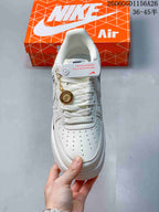 Top view showing the perforated toe, white laces, and round metallic lace charm