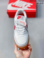 Top view showing the white toe box, laces, padded tongue, and red tongue branding.