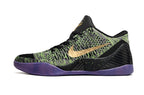 Side view of a black, green, and purple low-top shoe.