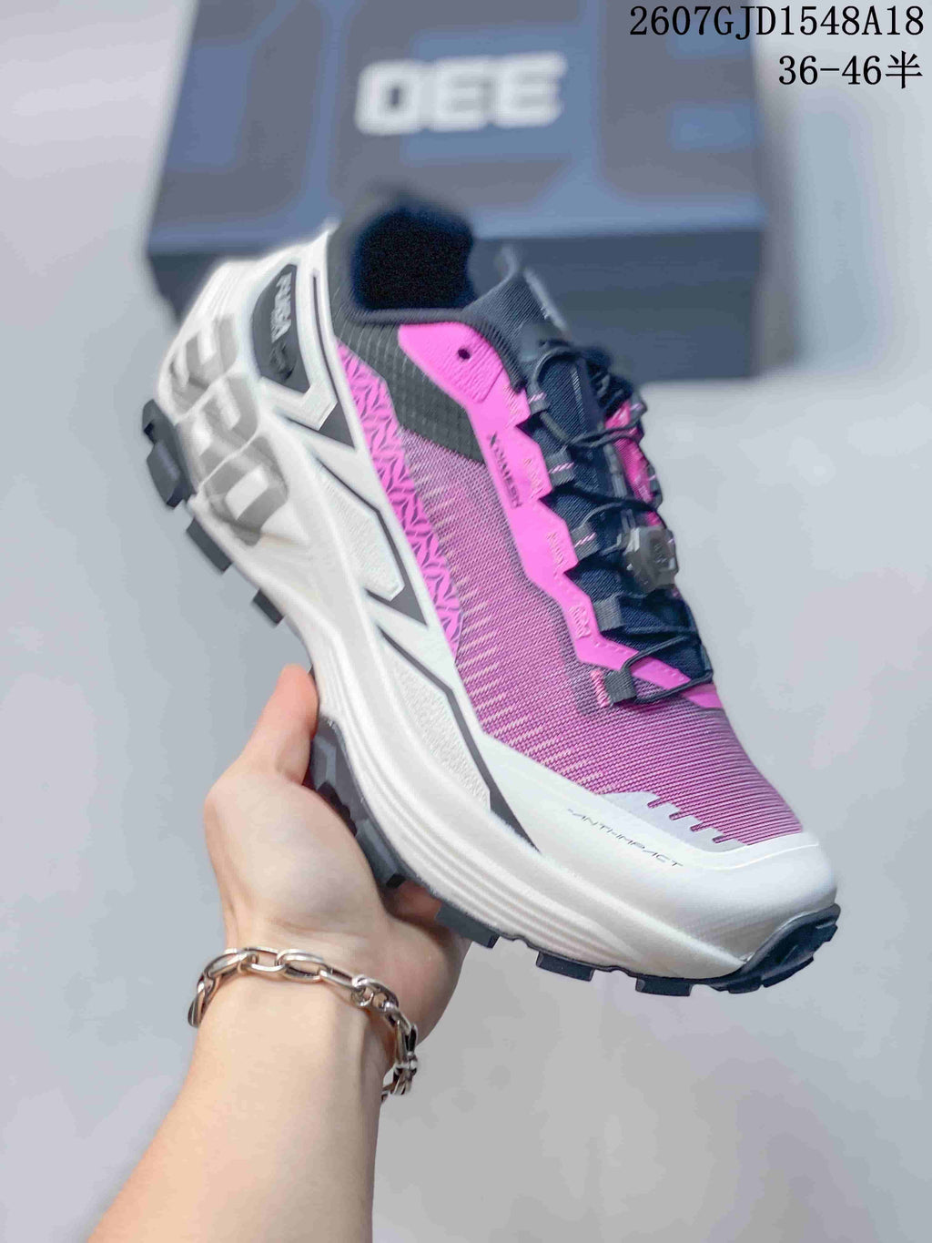 Angled side view showing the layered white midsole, pink upper and black outsole lugs.