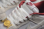 Close-up of the white laces, Nike tongue label, textured off-white panels, and gold-tone clasp detail.