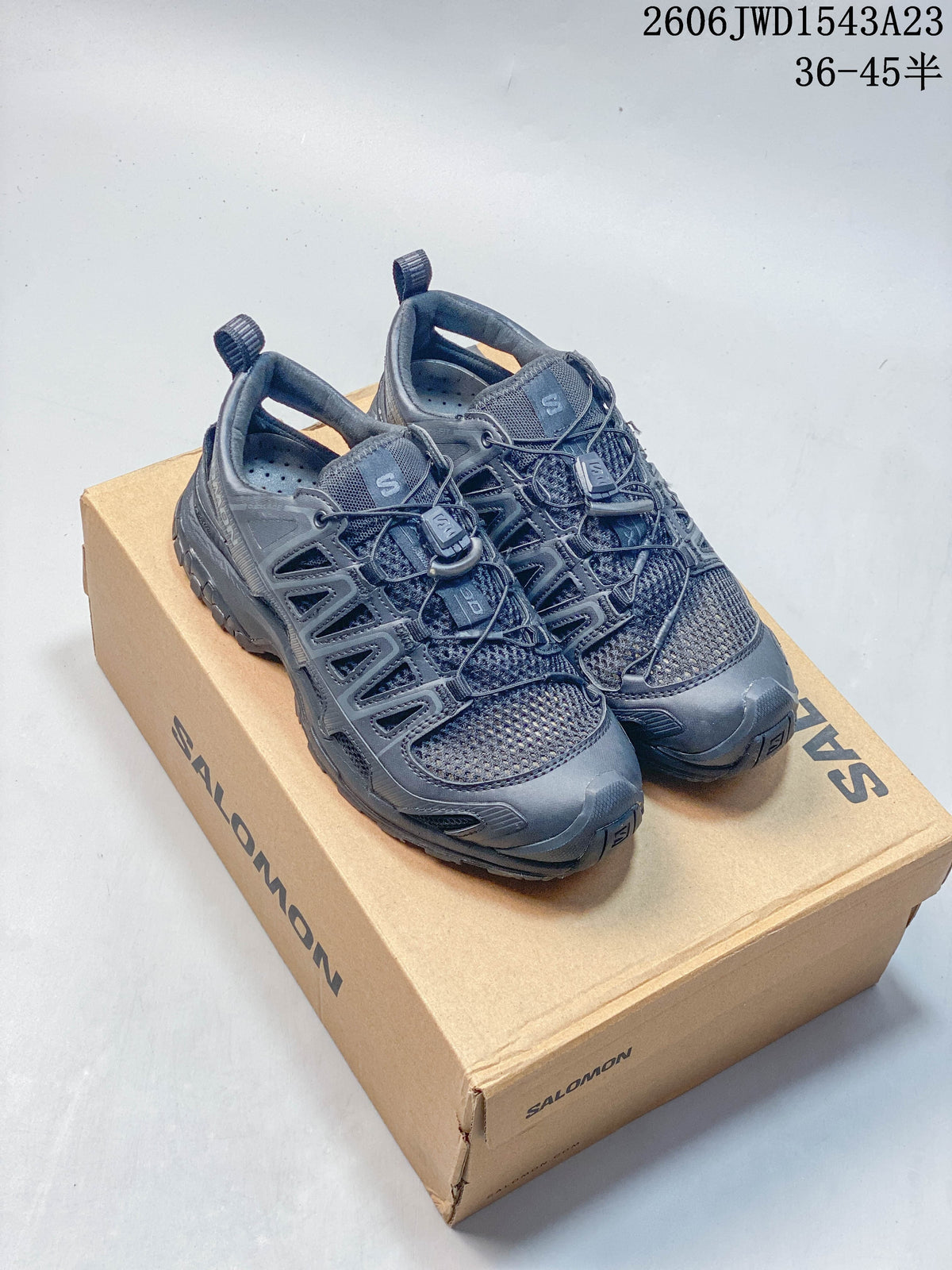 Pair of dark gray Salomon XA PRO 3D AMPHIB shoes on a branded box